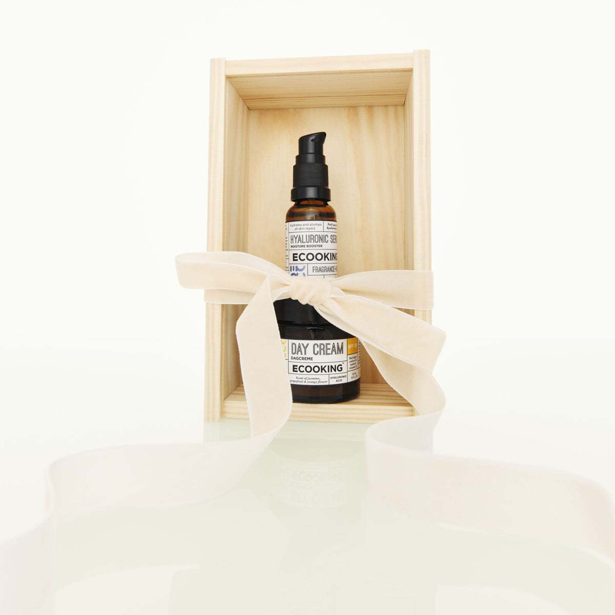 Hyaluronic Serum og dagcreme fra ECOOKING i en trækasse med et hvidt silkebånd bundet om.