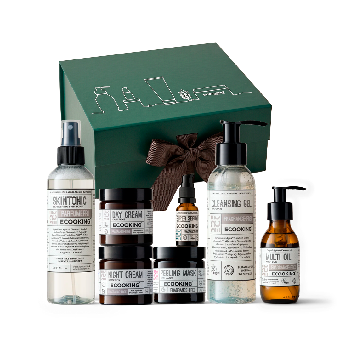 Venindeboksen fra ECOOKING: en grøn gaveæske med brun sløjfe og de syv parfumefri produkter foran – Skintonic, Dagcreme, Natcreme, Peel Maske, Super Serum, Rensegel og Multi Olie.
